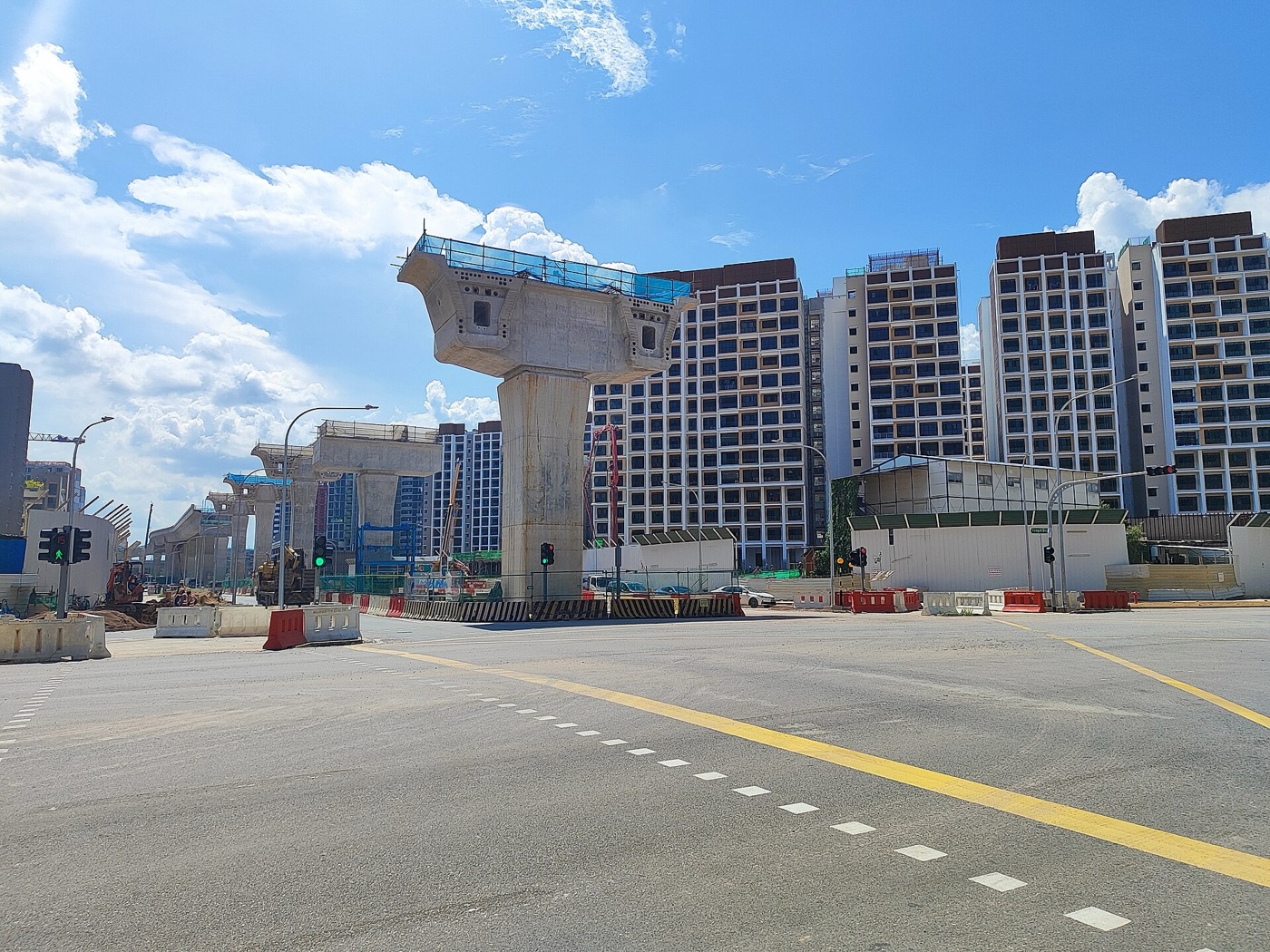 New HDB blocks in Tengah beside a road junction under construction.