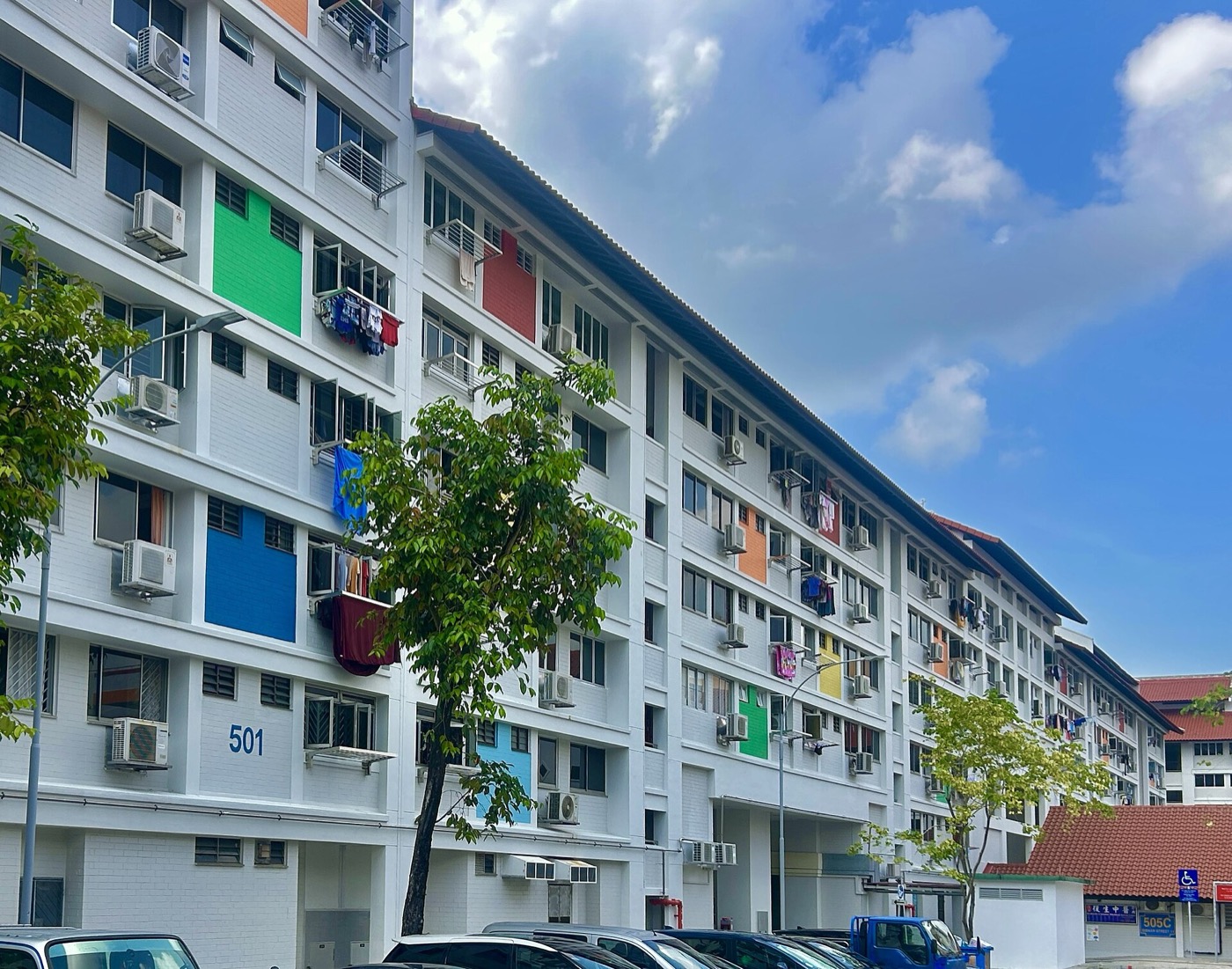HDB block 501 in Bishan, Singapore, with air-conditioner units and laundry poles along the facade.
