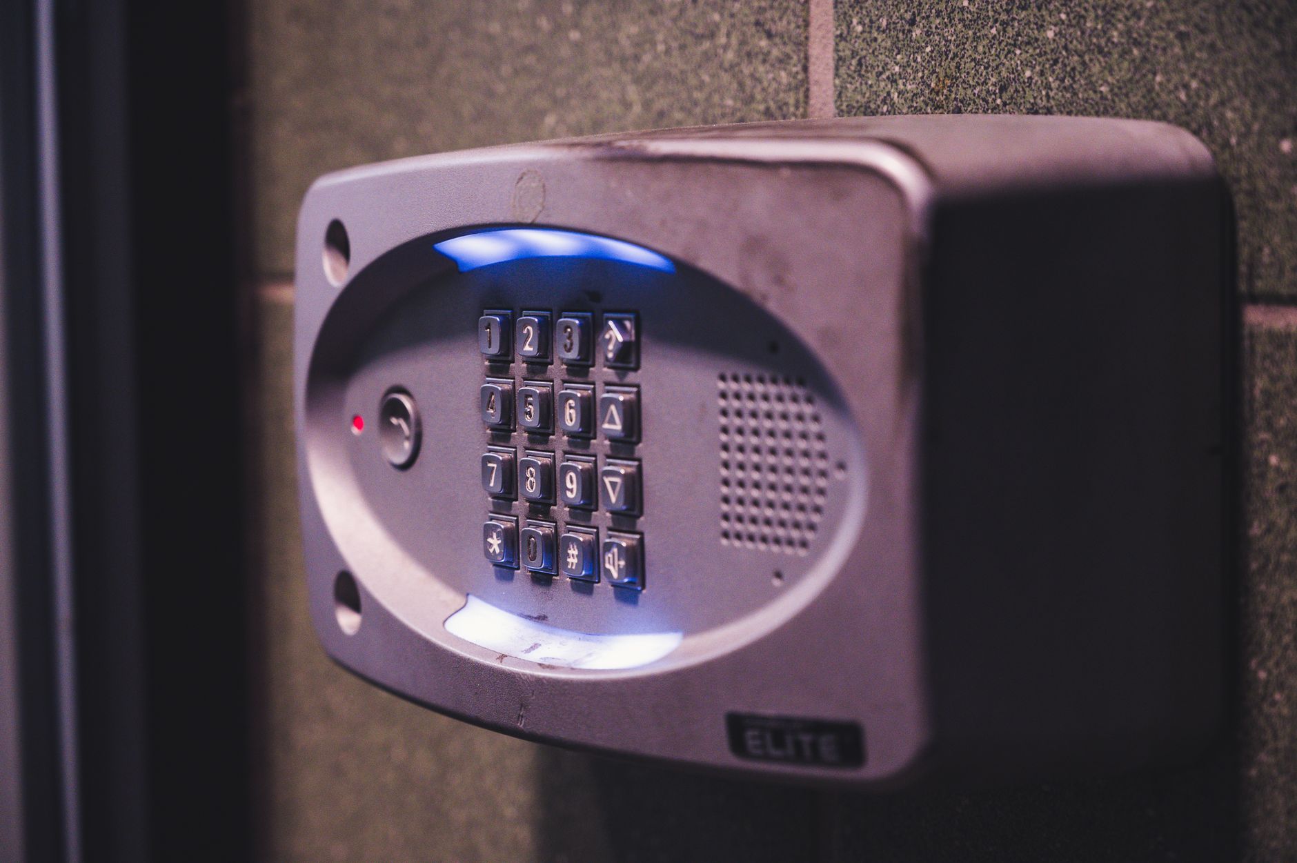 Lit keypad beside a home entrance